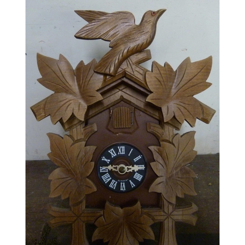 304 - A Black Forest beech and faux wood cuckoo clock