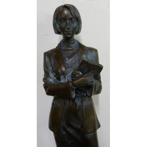 316 - A bronze figure of an office worker, on black marble socle