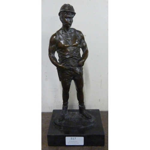 317 - A bronze figure of a miner, on black marble socle