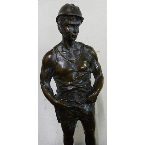 317 - A bronze figure of a miner, on black marble socle