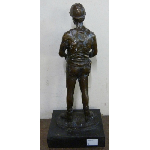 317 - A bronze figure of a miner, on black marble socle