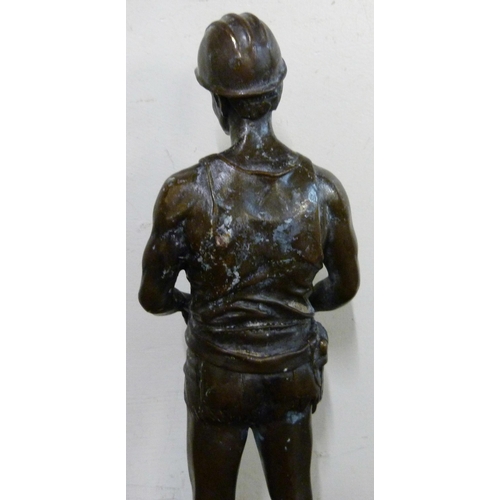 317 - A bronze figure of a miner, on black marble socle