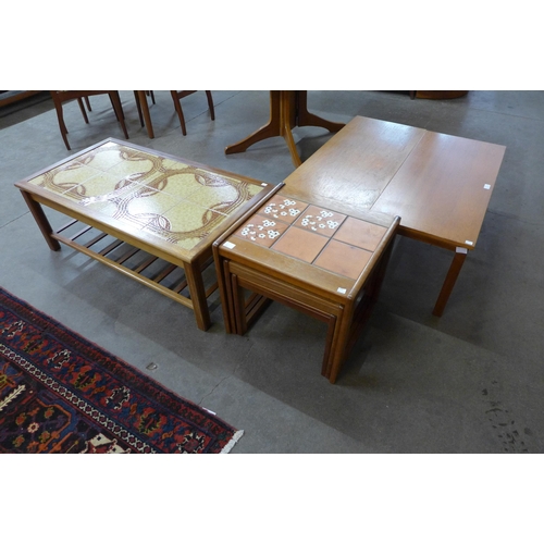 32 - A teak and tiled topped coffee table, a tiled top nest of tables and two teak coffee tables
