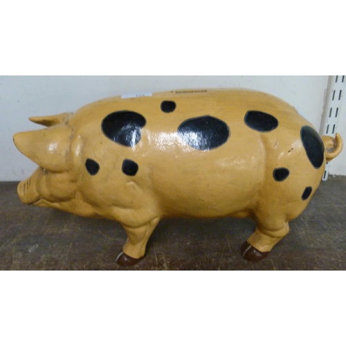 324 - A large painted metal pig shaped money box