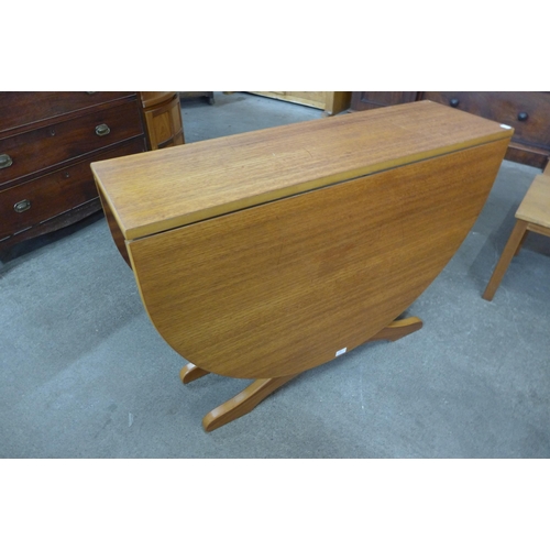 33 - A teak drop-leaf table