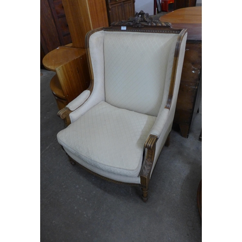 88 - An early 20th Century French carved walnut and fabric upholstered fauteuil chair