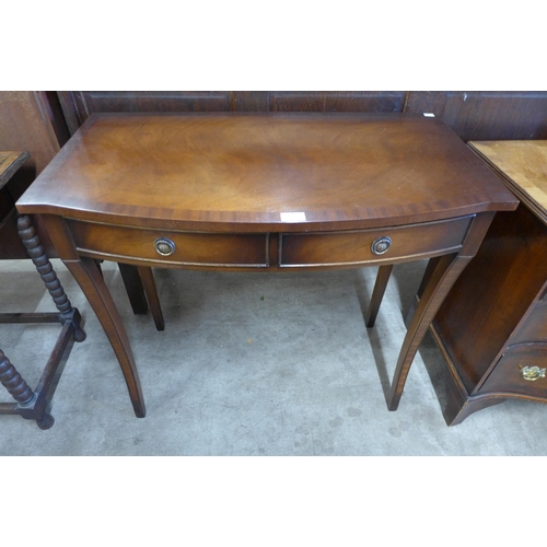 98 - A Regency style mahogany bow front two drawer side table