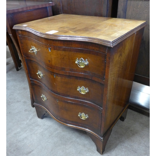 99 - A George III style mahogany serpentine bachelor's chest of drawers