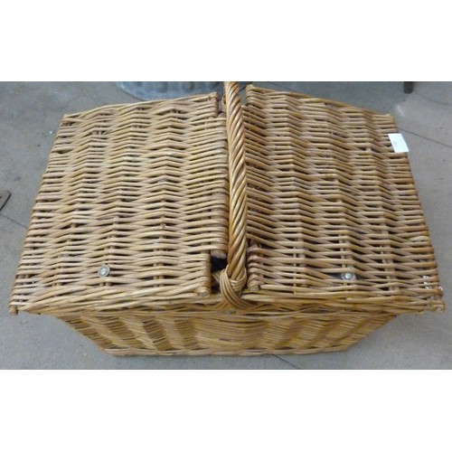 298 - A wicker picnic hamper, containing Brexton picnicware