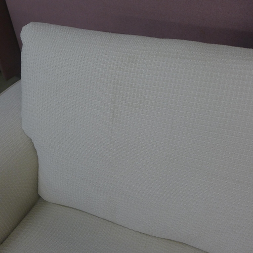 1511 - A Florian cream upholstered four seater sofa, RRP £3599