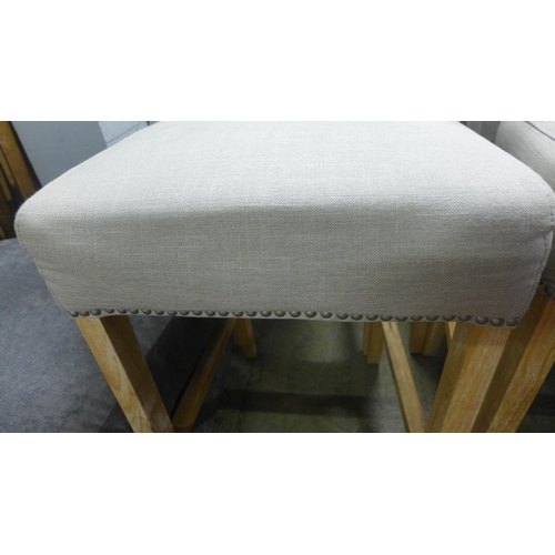 1543 - A pair of stone upholstered buttoned bar stools