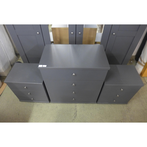 1551 - A large four door dark grey and mirrored wardrobe with a four drawer chest and a pair of bedside tab... 