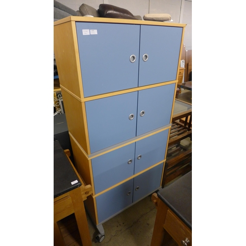 1595 - Two four door cabinets on wheels, can be stacked to make one eight door unit