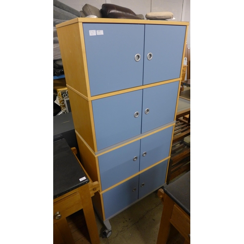 1595 - Two four door cabinets on wheels, can be stacked to make one eight door unit