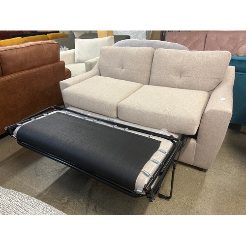 1529 - An oatmeal textured weave upholstered two seater sofa bed