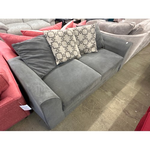 1537 - A mid grey three seater sofa with patterned scatter cushions, damaged