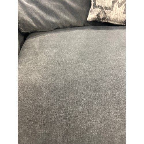 1537 - A mid grey three seater sofa with patterned scatter cushions, damaged