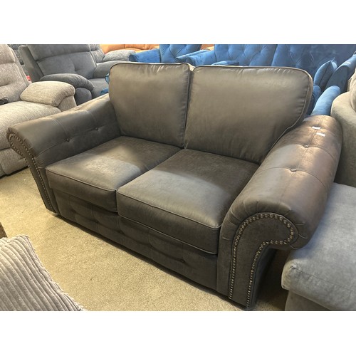 1628A - A charcoal vegan leather upholstered two seater sofa (damaged)