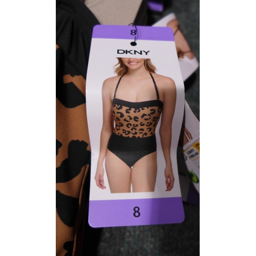 3312 - Four black and leopard print DKNY swimming costumes - size 8 * this lot is subject to VAT