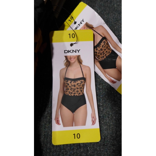 3314 - Four black and leopard print DKNY swimming costumes - size 10 * this lot is subject to VAT