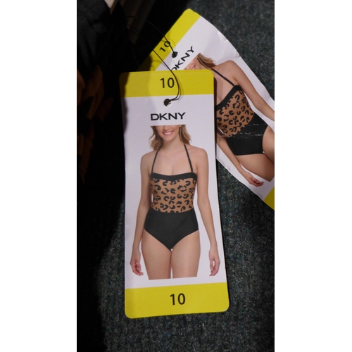 3315 - Four black and leopard print DKNY swimming costumes - size 10 * this lot is subject to VAT