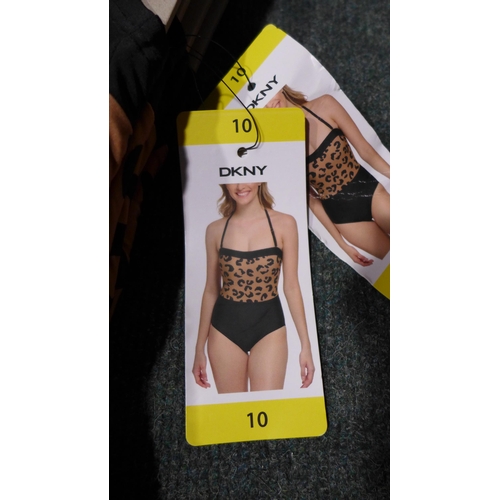 3316 - Four black and leopard print DKNY swimming costumes - size 10 * this lot is subject to VAT