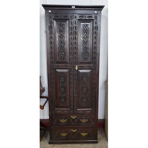 122 - A George III carved oak two door housekeeper's cupboard