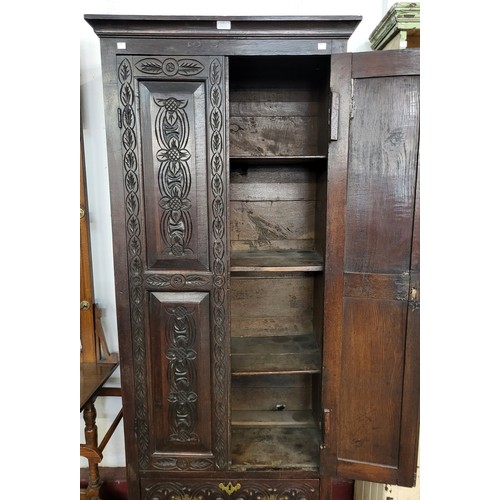 122 - A George III carved oak two door housekeeper's cupboard