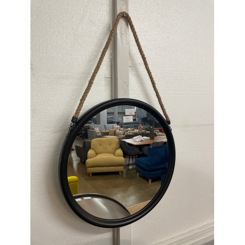 1312 - A medium round black metal mirror on a hanging rope H46cm (JRG1809)