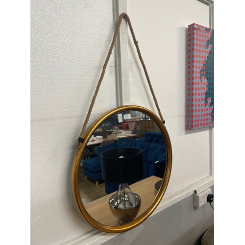 1313 - A large gold metal mirror on hanging rope, 58cms (JRG1114)   #