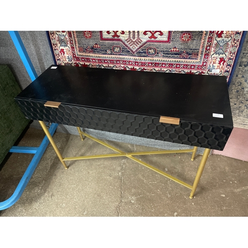 1389 - A black and gold console table with geometric patterned drawer