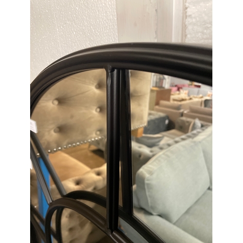 1341 - A large black arched mirror