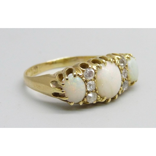 982A - An 18ct gold three stone opal and diamond ring, 3.2g, M