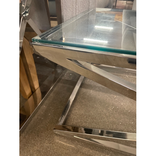 1466 - A glass and chrome 'X' base coffee table * this lot is subject to VAT