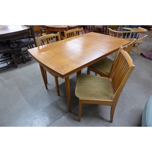 9 - A teak rectangular extending dining table and four chairs