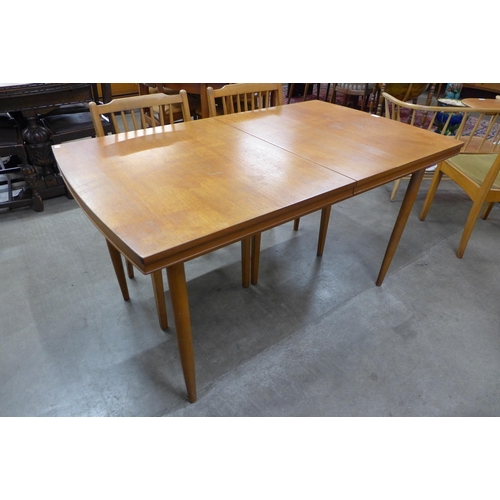 9 - A teak rectangular extending dining table and four chairs