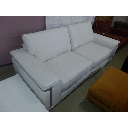 1522 - A Florian cream upholstered four seater sofa, RRP £3599