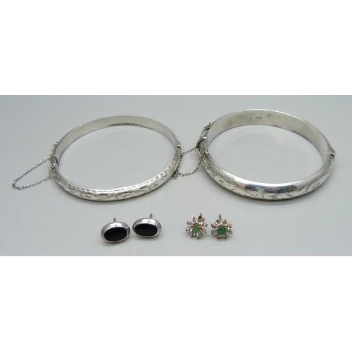 1009 - Two silver bangles, a pair of silver earrings and a pair of unmarked cluster earrings