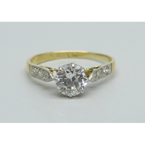 1010 - An 18ct gold, platinum and brilliant cut solitaire diamond ring with diamond shoulders, approximatel... 