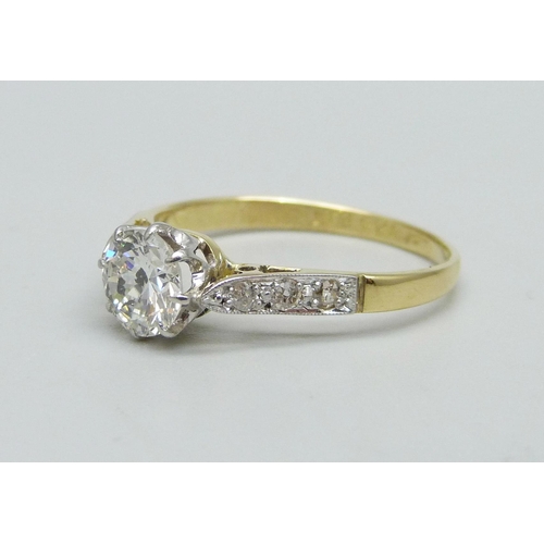 1010 - An 18ct gold, platinum and brilliant cut solitaire diamond ring with diamond shoulders, approximatel... 