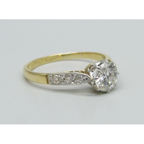 1010 - An 18ct gold, platinum and brilliant cut solitaire diamond ring with diamond shoulders, approximatel... 