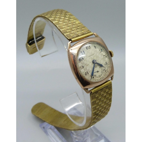 1026 - A 9ct gold cased wristwatch, dial signed Dominant, 27mm case