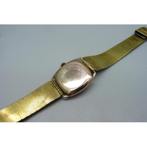 1026 - A 9ct gold cased wristwatch, dial signed Dominant, 27mm case