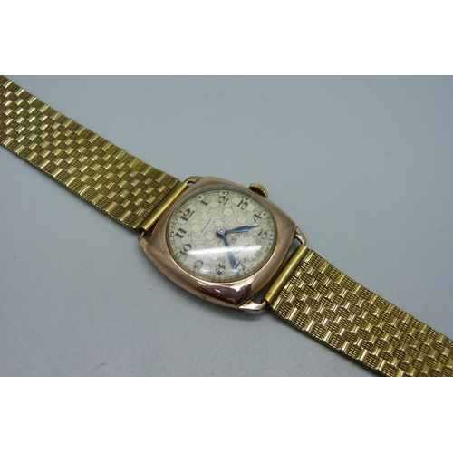 1026 - A 9ct gold cased wristwatch, dial signed Dominant, 27mm case