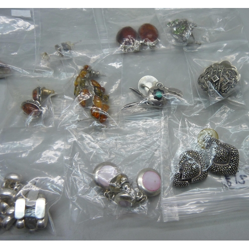 1038B - A collection of fourteen pairs of silver earrings