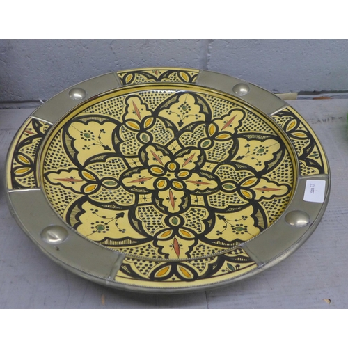 1099 - A Moroccan large shallow bowl, a brown glass bottle embellished with leaves, a lemon yellow glass ca... 