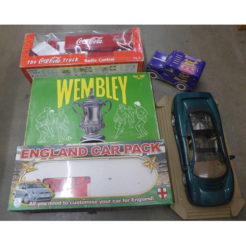 1108 - A Wembley board game, a Coca-Cola truck, an England car pack, a Maisto 1/18th scale model of a Jagua... 