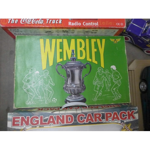 1108 - A Wembley board game, a Coca-Cola truck, an England car pack, a Maisto 1/18th scale model of a Jagua... 