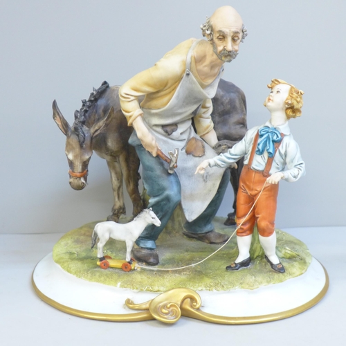 610 - A Neopolitan figure of a farrier and boy