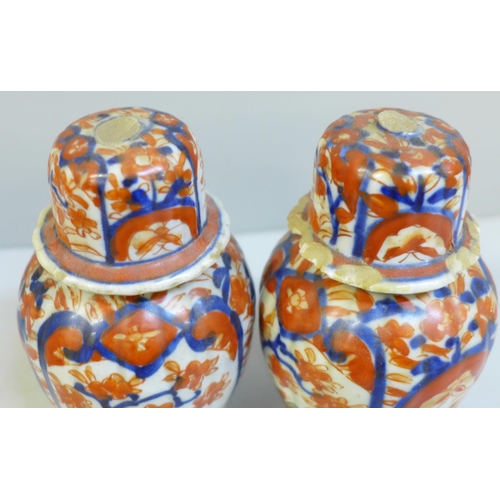 620 - A pair of Japanese Kutani bottle vases and a pair of Imari lidded vases, a/f